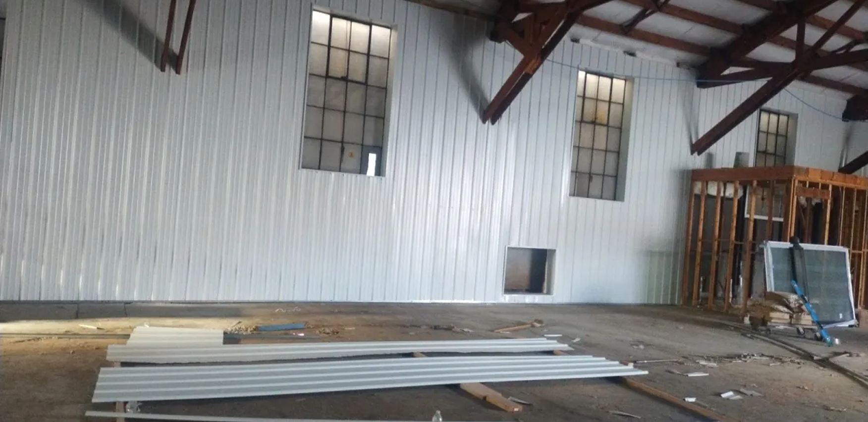 Construction site with metal beams and panels.